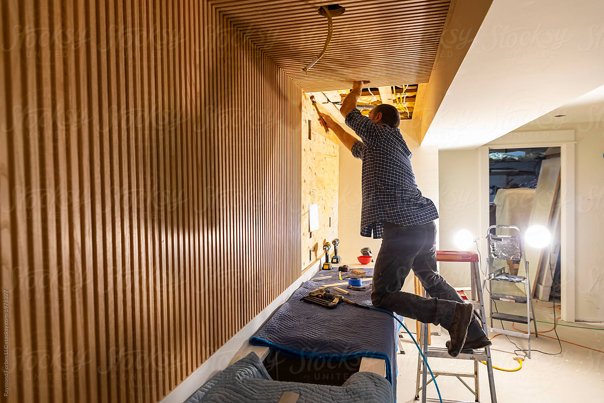 Blue Collar worker Carpenter building Vertical wood panel wall