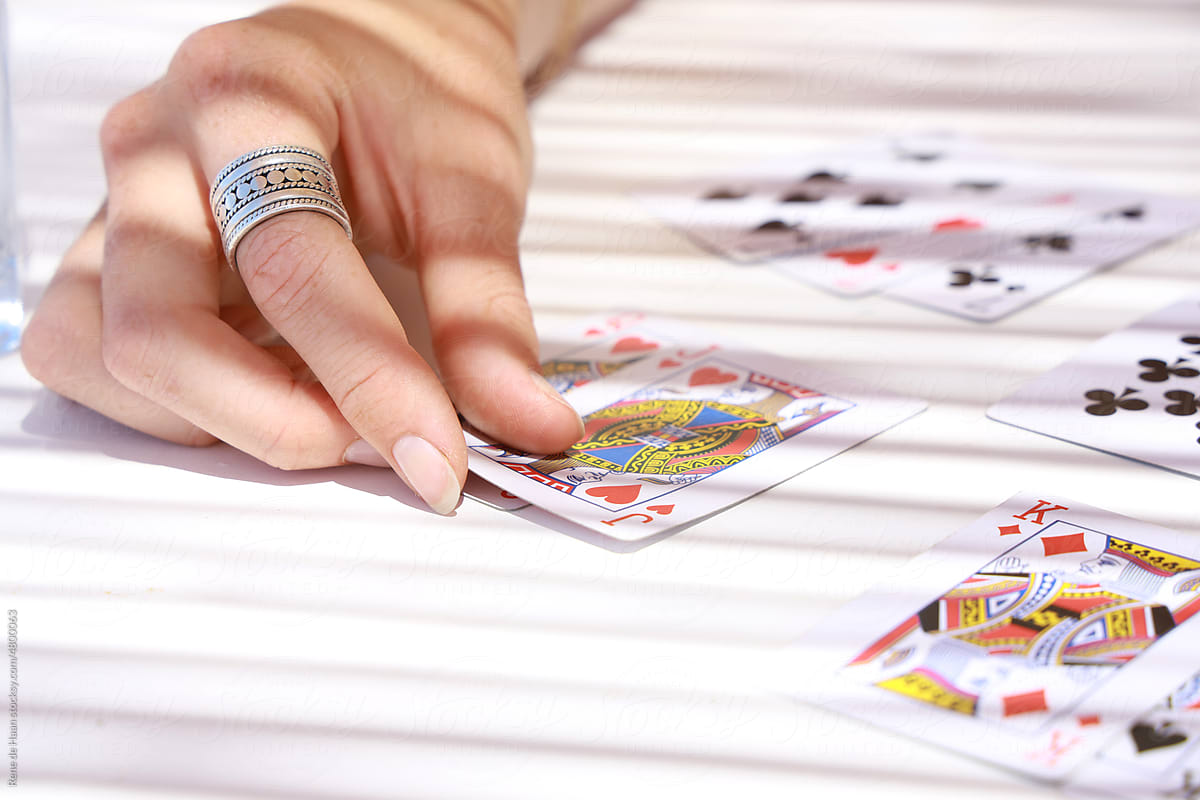 hand of woman playing card game