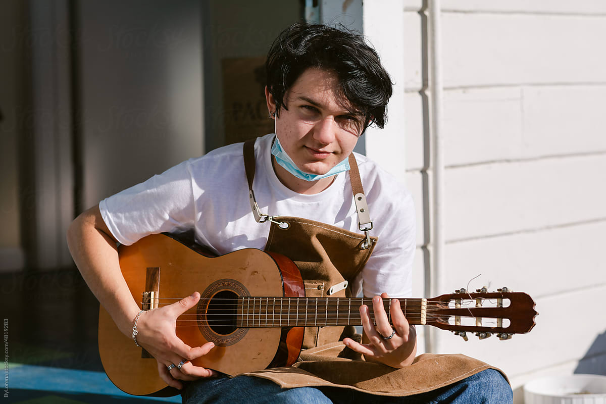 Young man playing the guitar outdoor