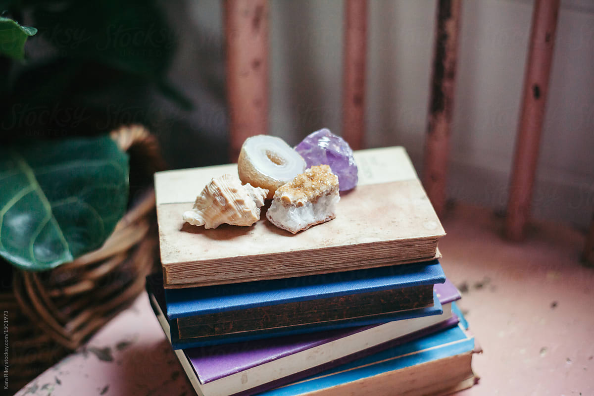Crystals and Shell on Stack of Old Books