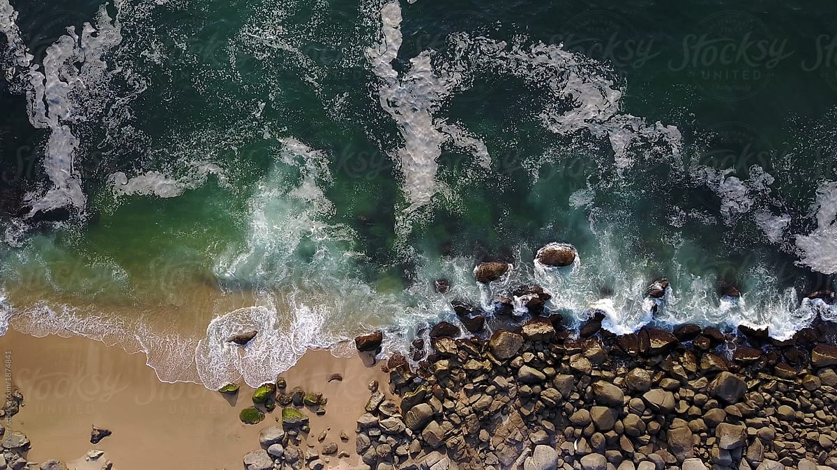Sea wave crashing on the beach - view from drone