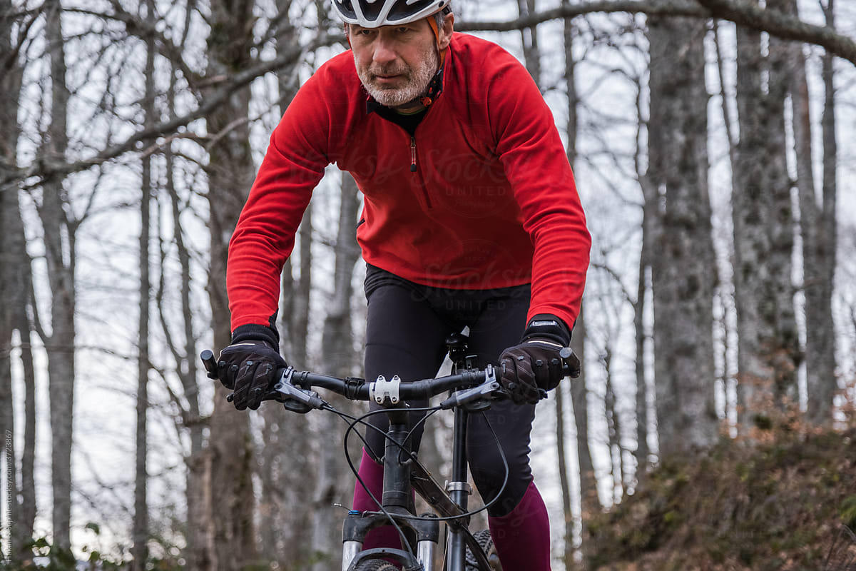 mature cyclist in concentration biking downhill