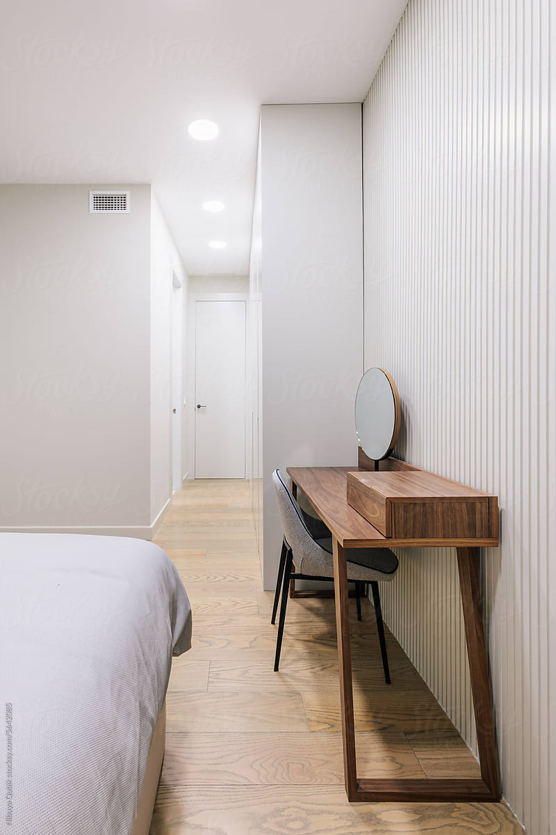 Cozy minimalist bedroom with beautiful wooden dresser