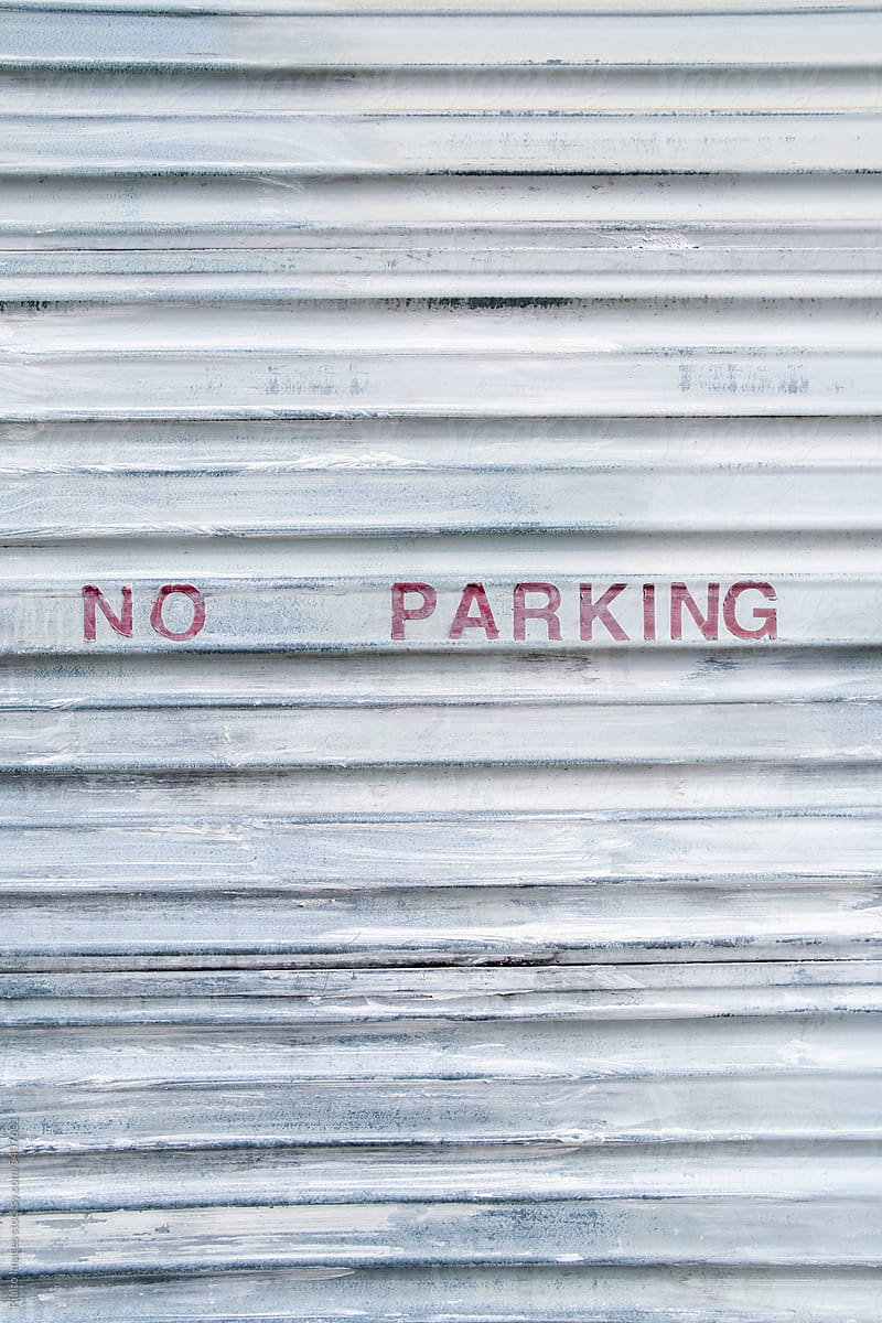 Stock image of NO PARKING sign on garage door