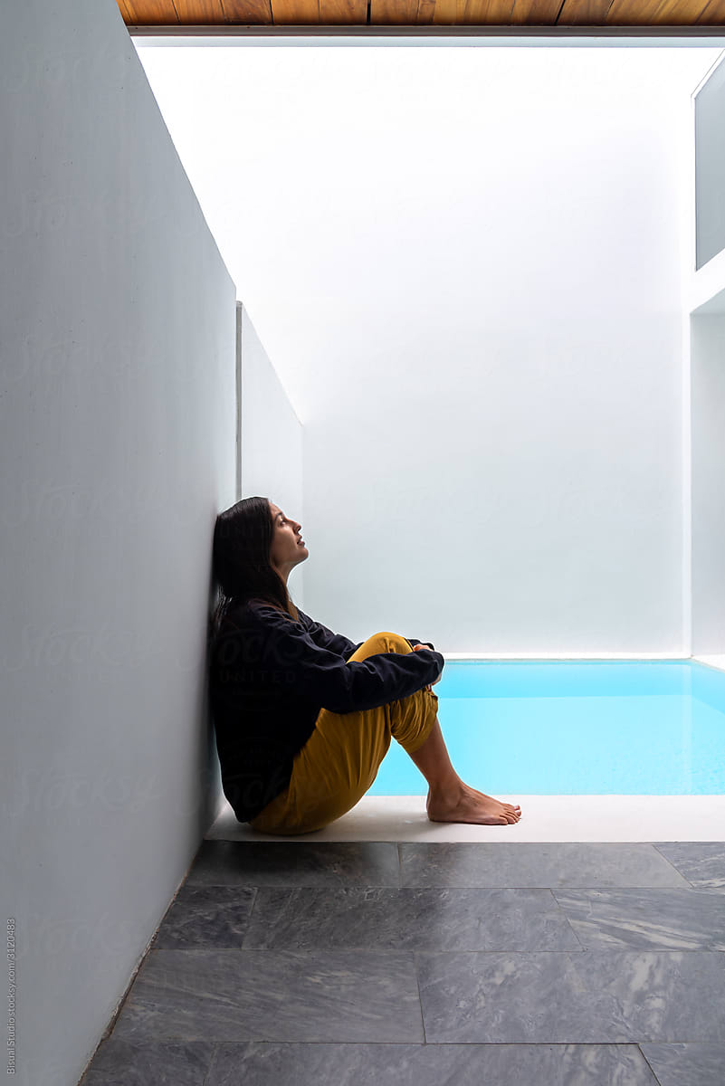 Woman on a luxury indoor pool in a modern house