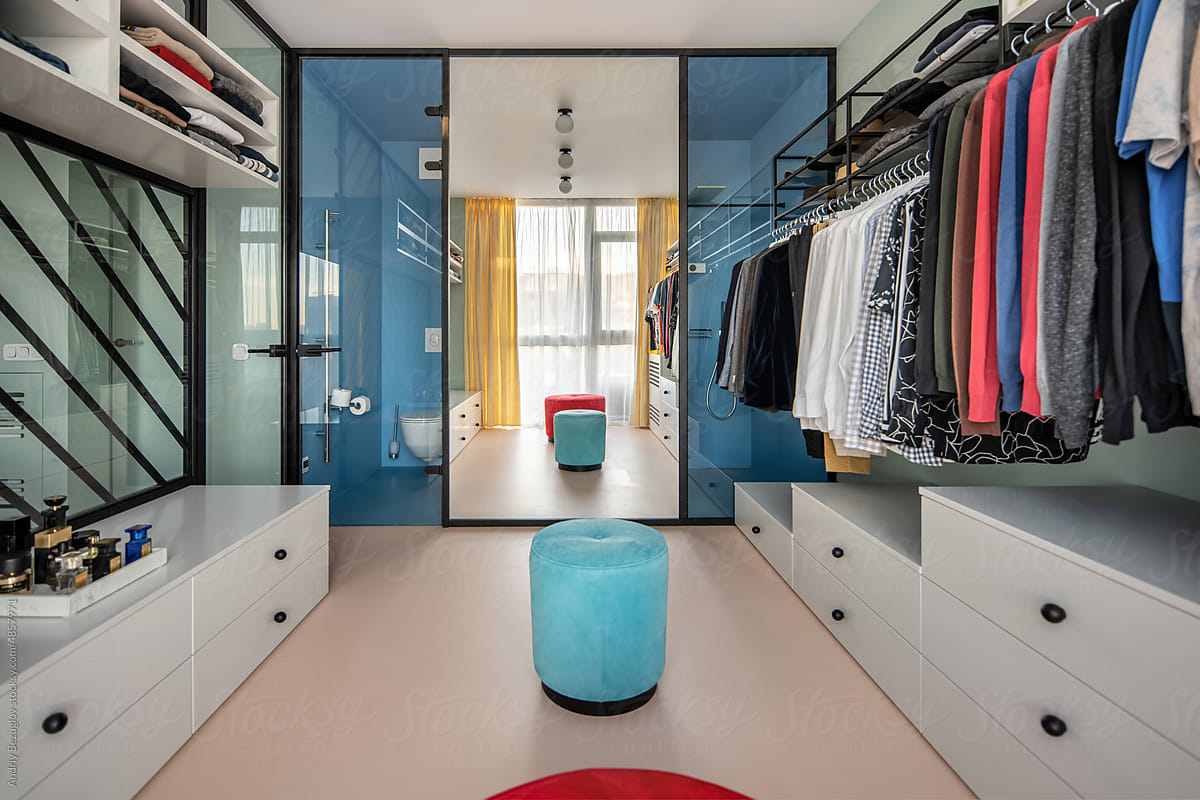 Huge modern wardrobe with different clothes for dressing room