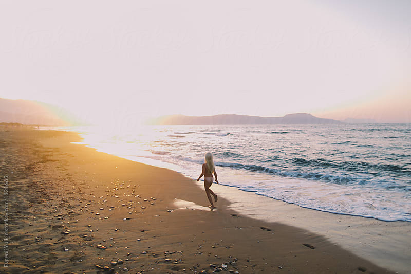 Little Naked Girl Running Along The Beach At Sunset By Evgenij Yulkin