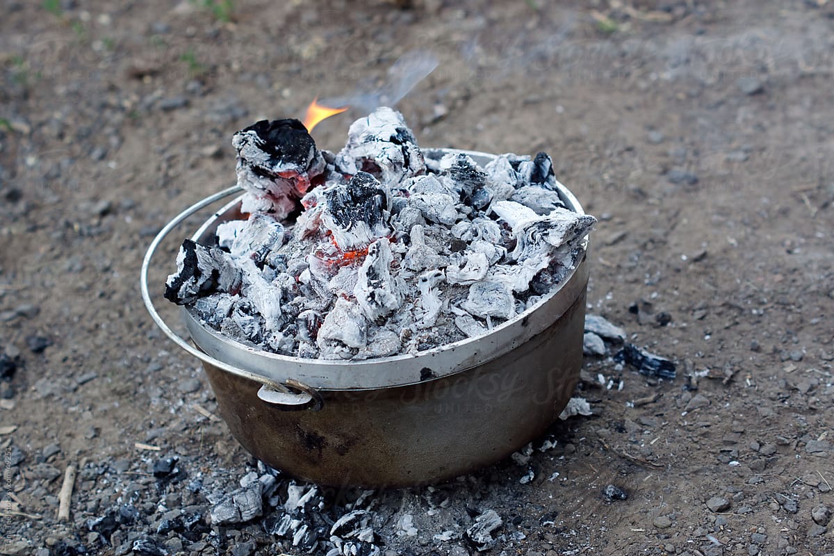 Burning coals cooking a dutch oven
