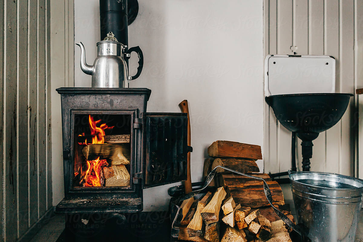 Rustic Cabin Interior - Logs Burning in Old-Fashioned Cast Iron Stove