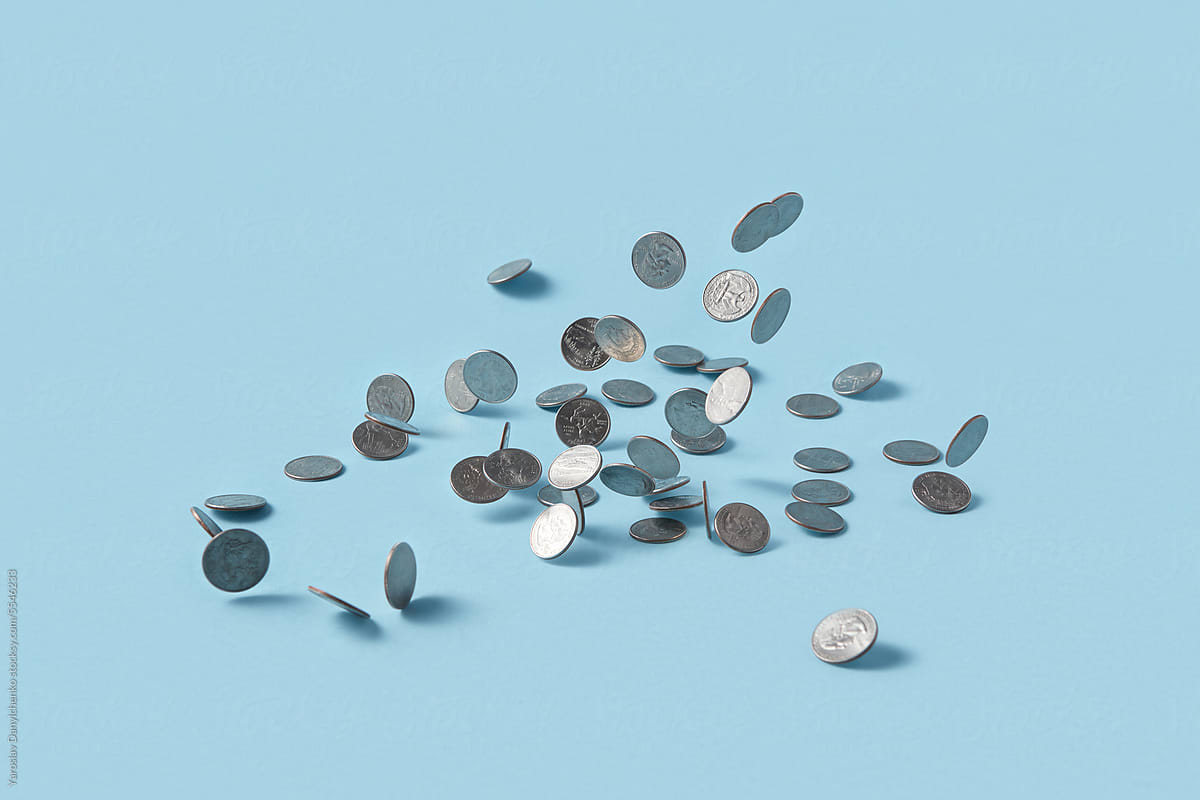 Quarter dollar coins on blue background.