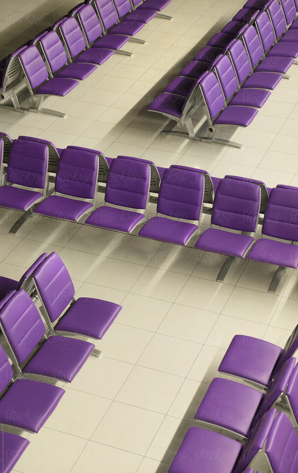 Purple chairs in row in waiting room.