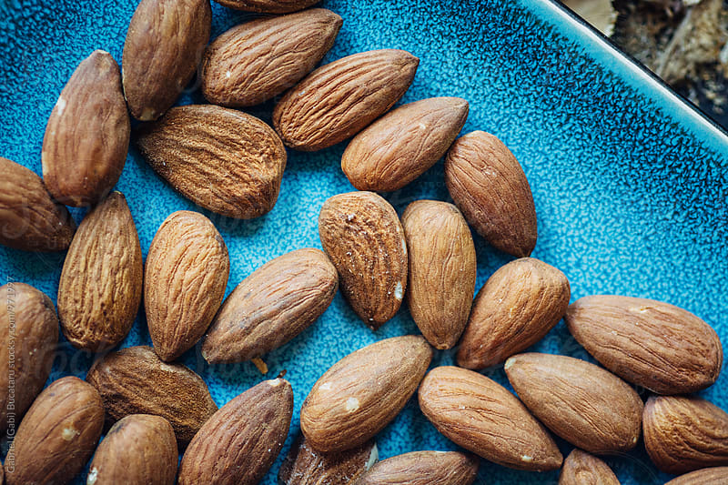 Almonds macro on a blue plate