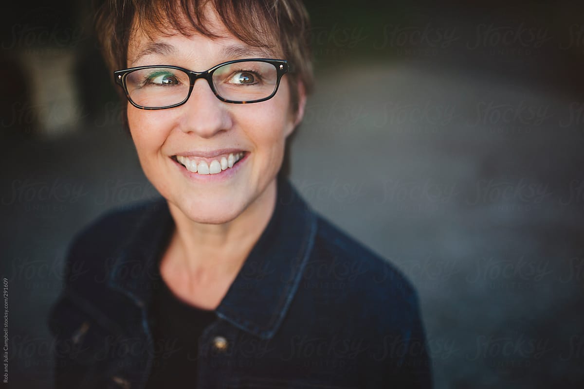 Middle Aged Retired Woman Wearing Glasses Smiling Outside By Stocksy Contributor Rob And 