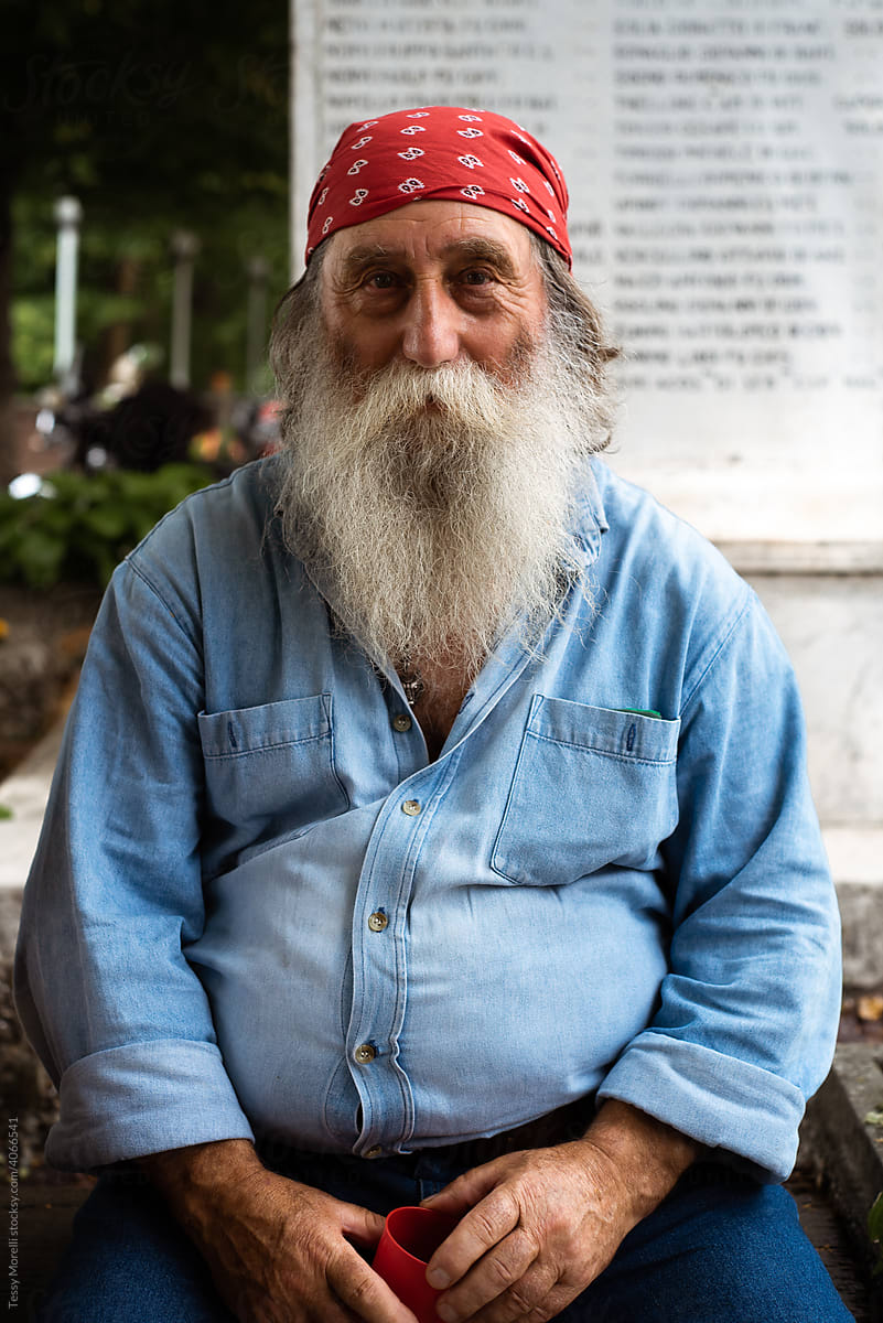 Man with a red bandana and denim shirt smiling