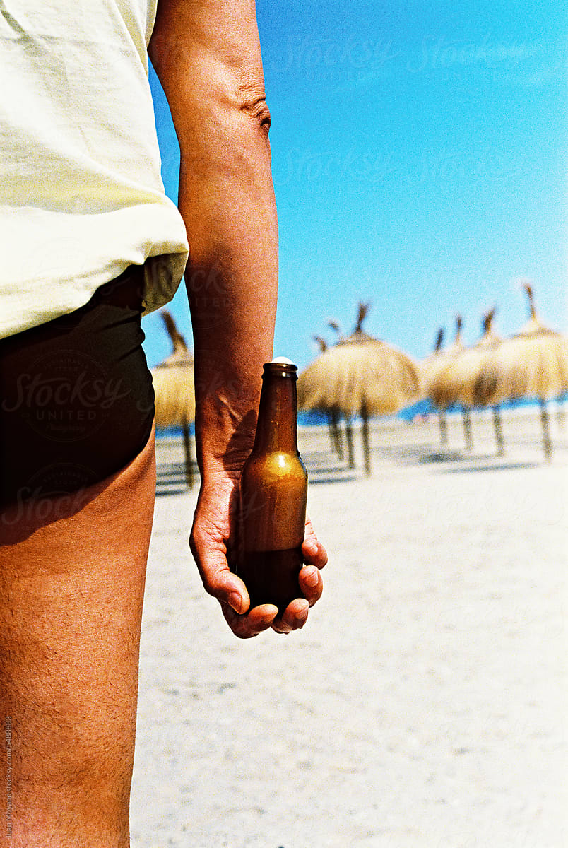 man with a refreshing beer on the beach, 35 mm film