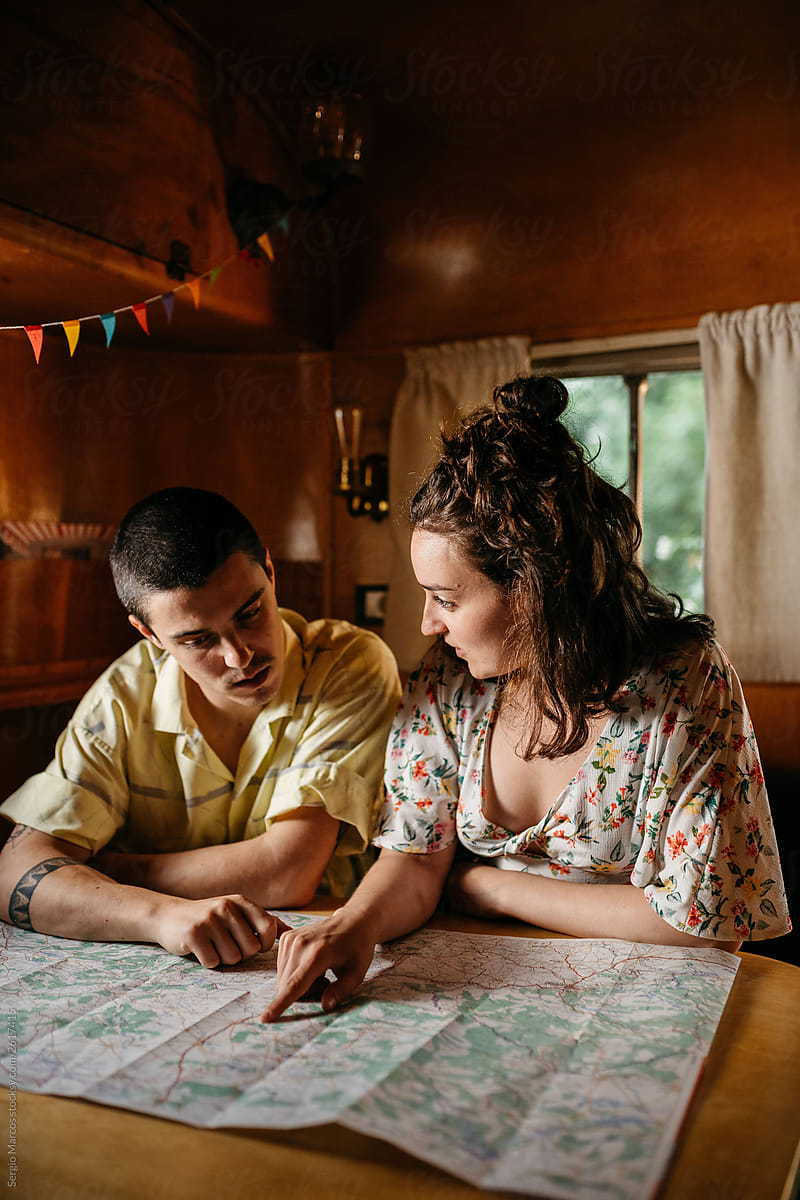 Couple reading map in camper