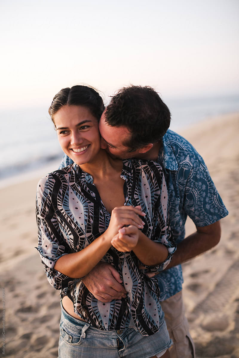 Cuddling Affectionate Couple On The Beach At Sunset By Stocksy Contributor Rob And Julia