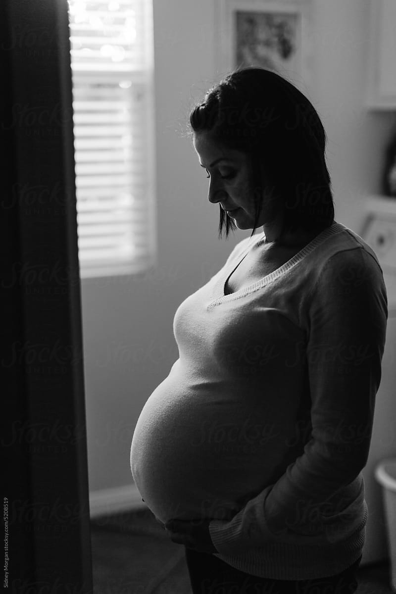 Woman Looking at Pregnant Belly