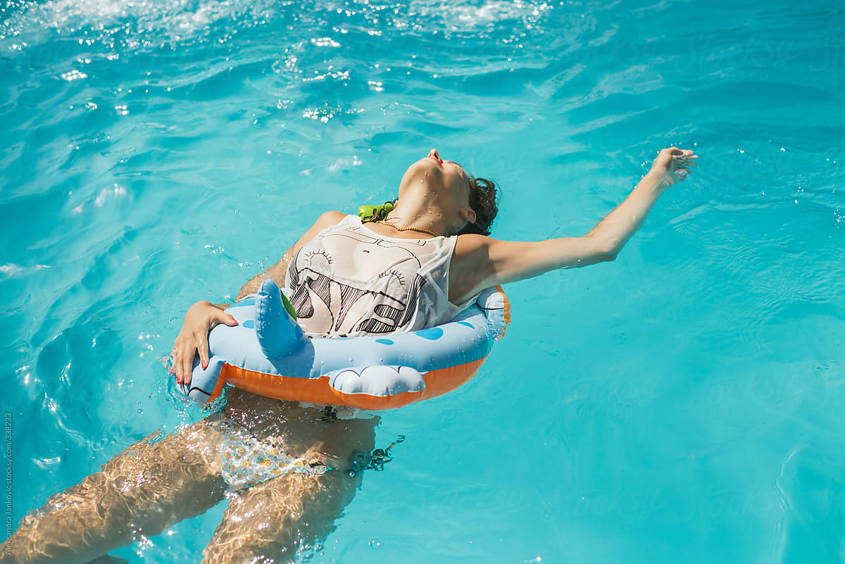 Anonymous Woman With Inflatable Water Tube Relaxing In The Swimming Pool