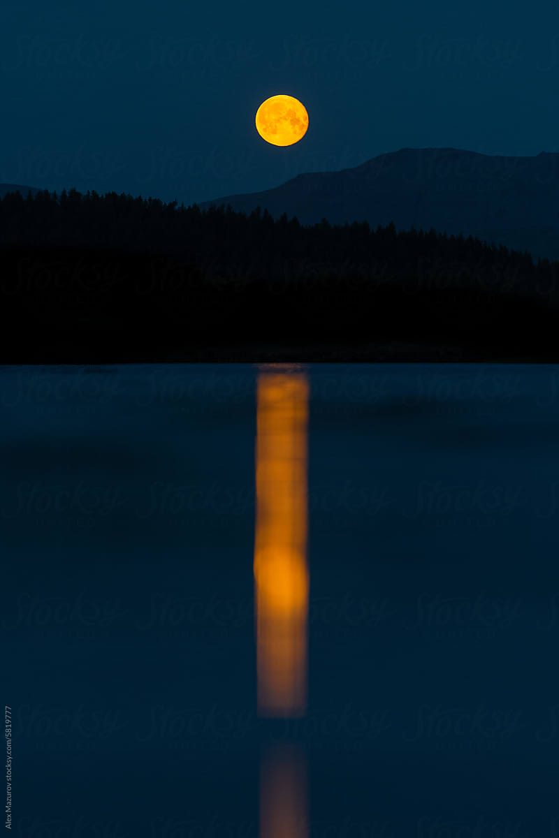 Moonrise over the lake in the mountains