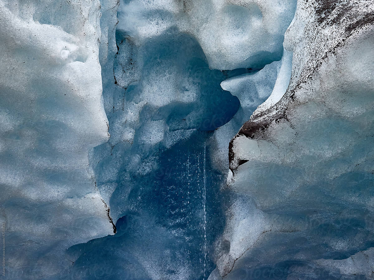 Global warming, meltwater flows off dirty glacier ice in summer