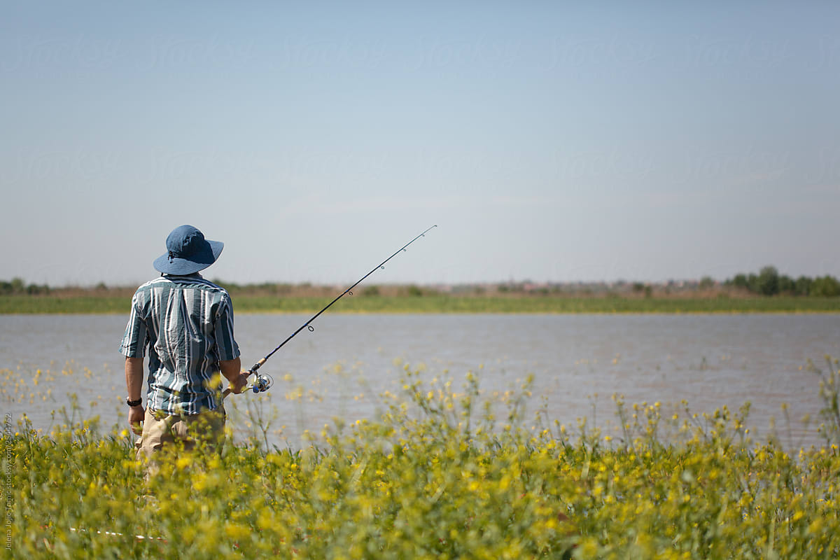 Stock photo of a man fishing on a summer day