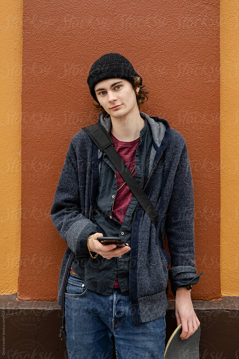 Young Male Looks At Camera With Cell Phone