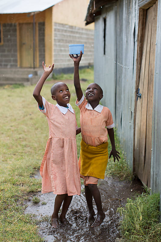 School children having fun in the rain. Kenya.