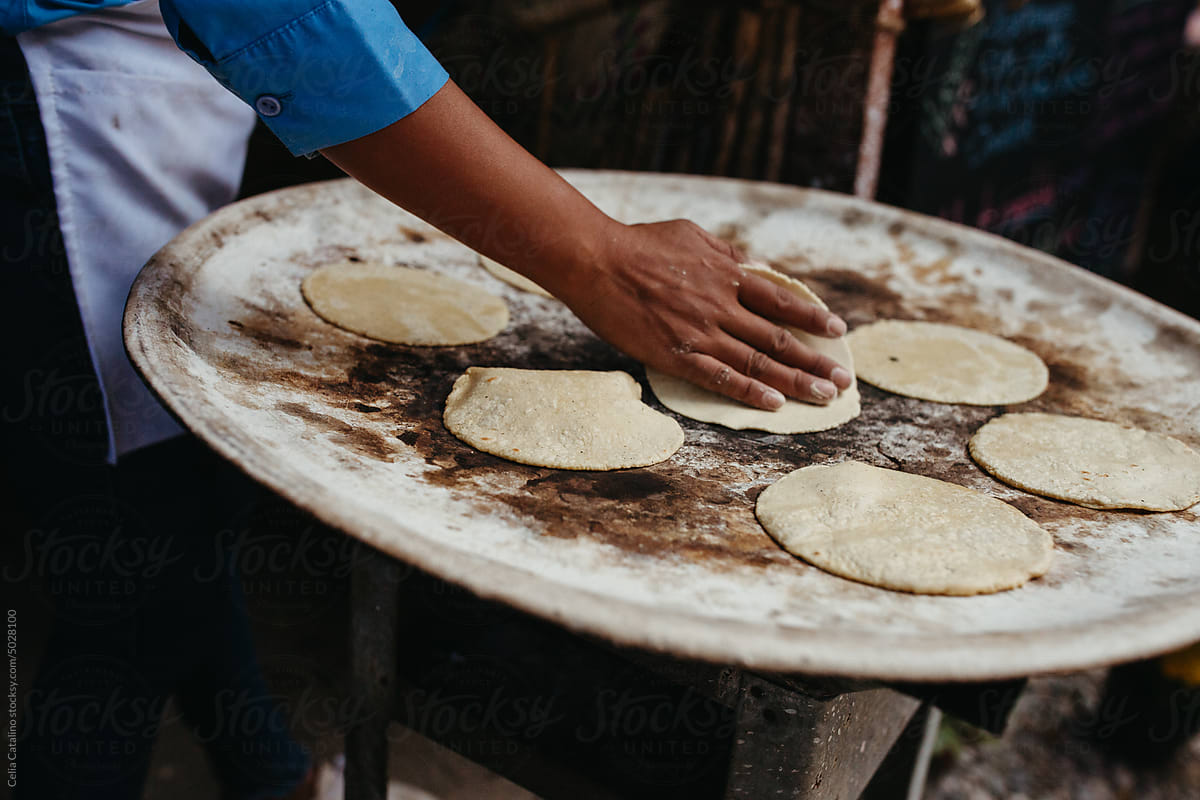 Tortillas On A Comal by Stocksy Contributor Celia Catalino - Stocksy
