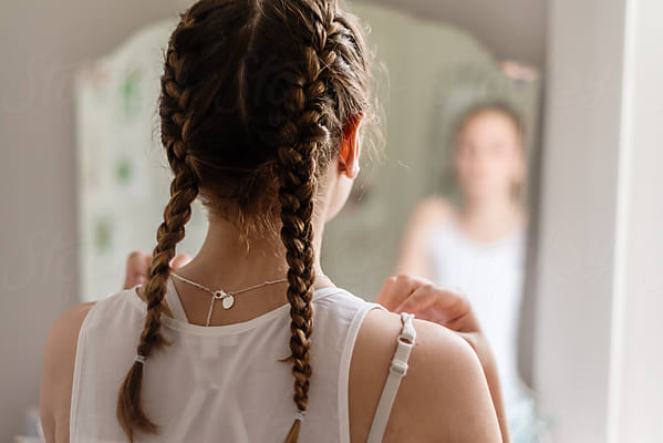 Teen Girl Braiding Hair In Mirror by Stocksy Contributor Gillian Vann -  Stocksy