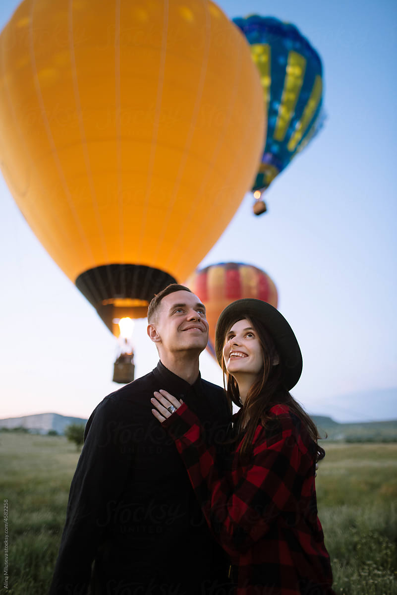 Young couple enjoying hot air balloons festival