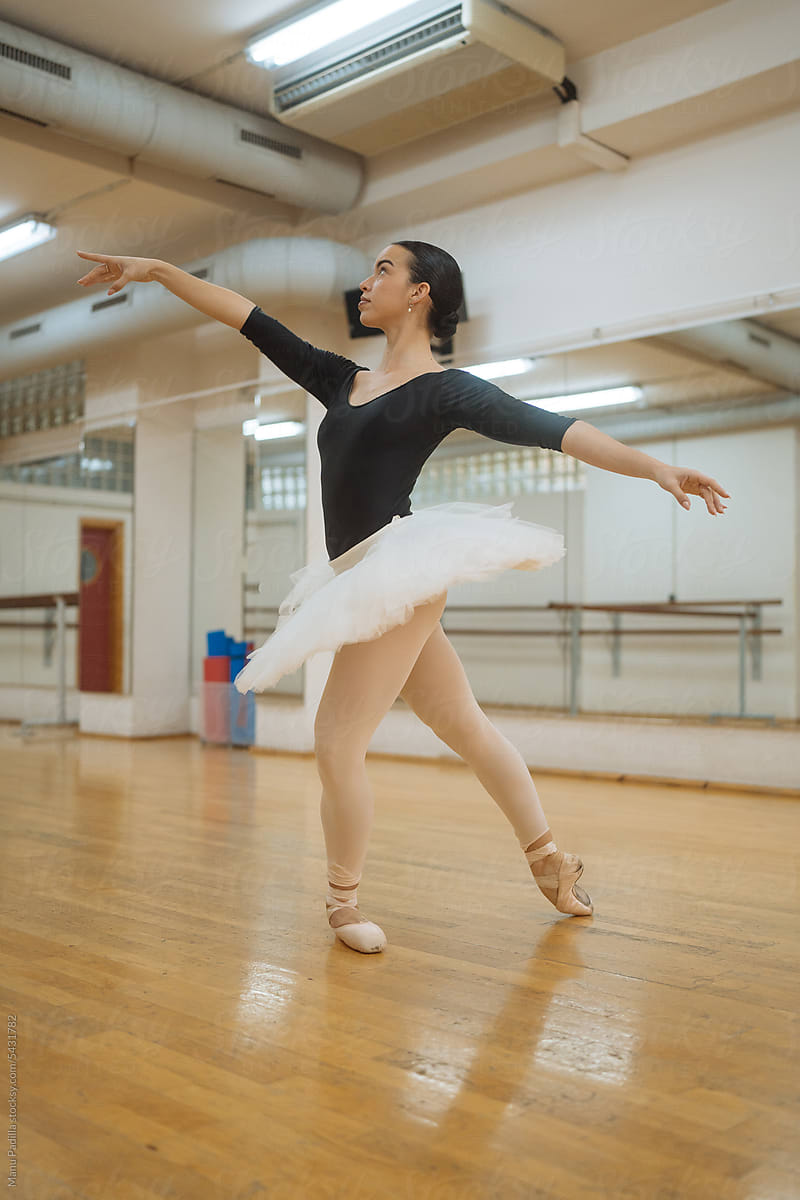 Talented ballerina dancing in studio during rehearsal