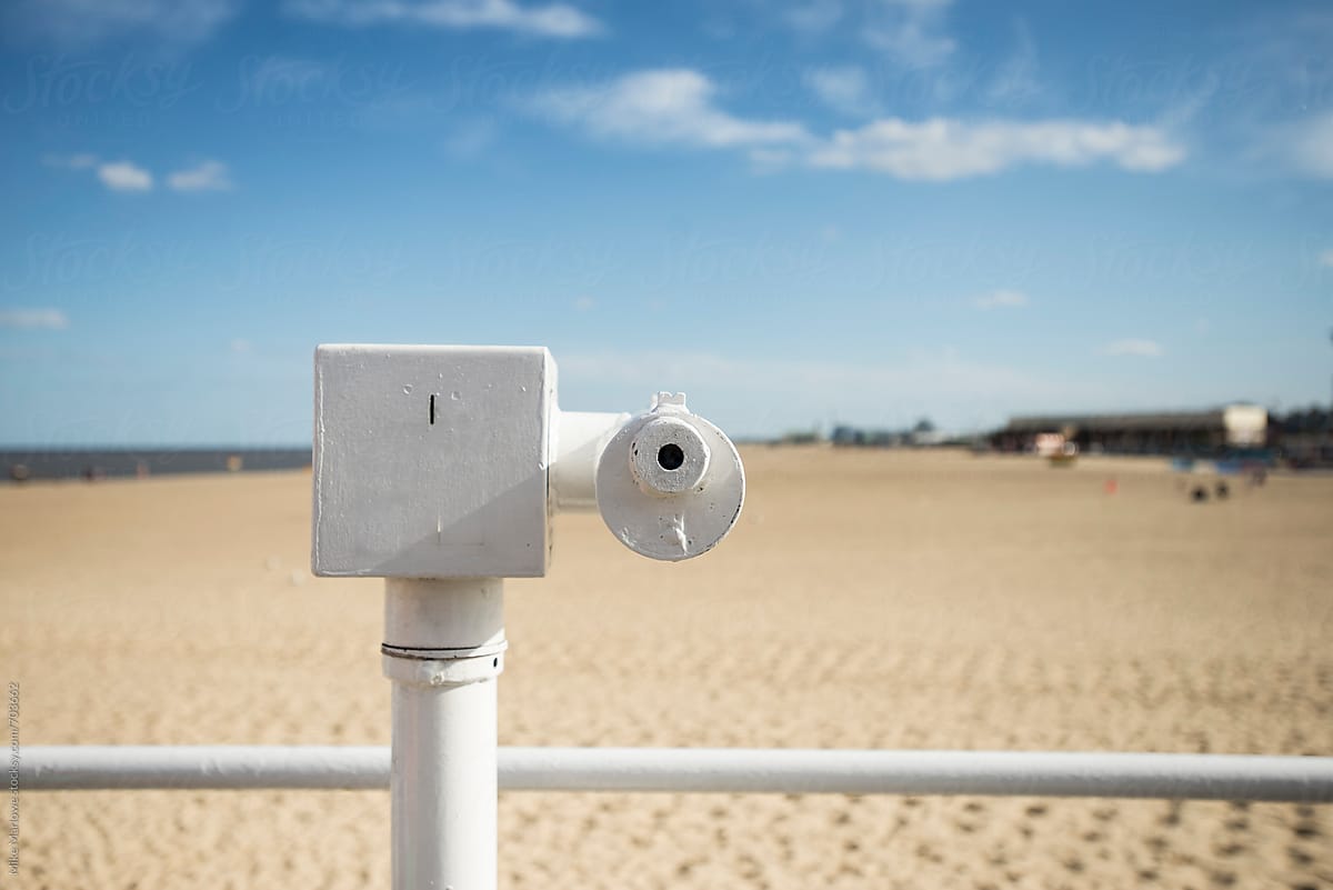 A telescope in a remote location at a beach on a bright sunny day