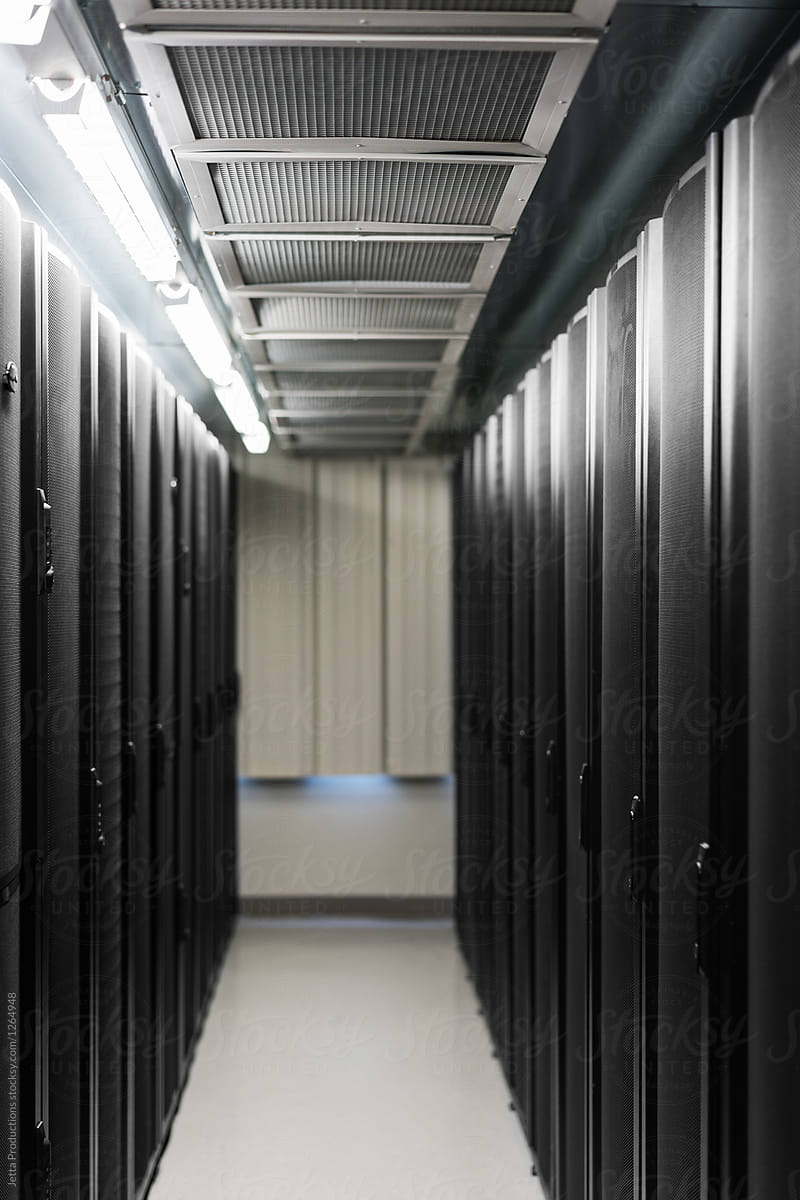 Vertical shot of lit corridor between two banks of servers