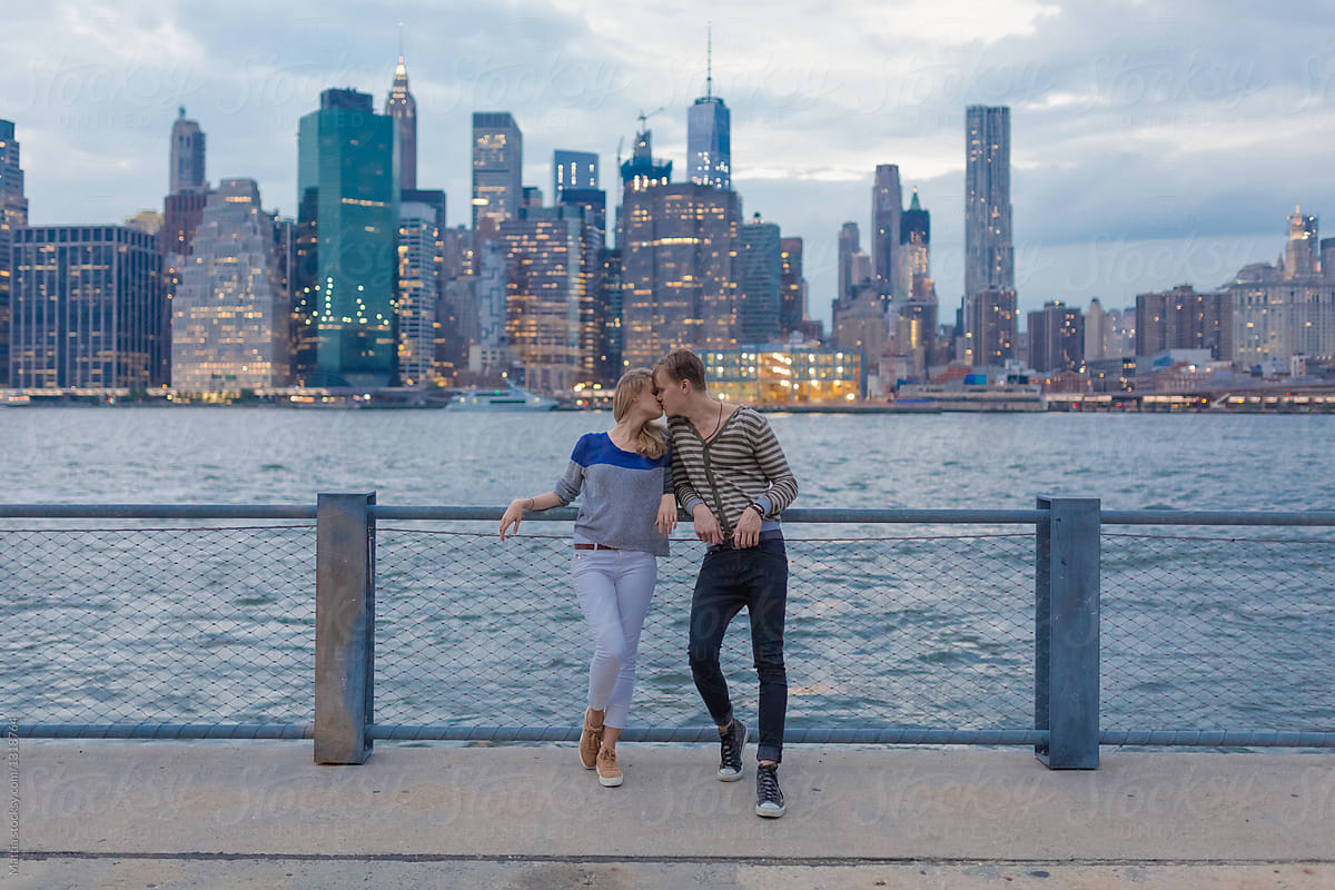 Young Couple in Front Of Manhattan Skyline . New York City US