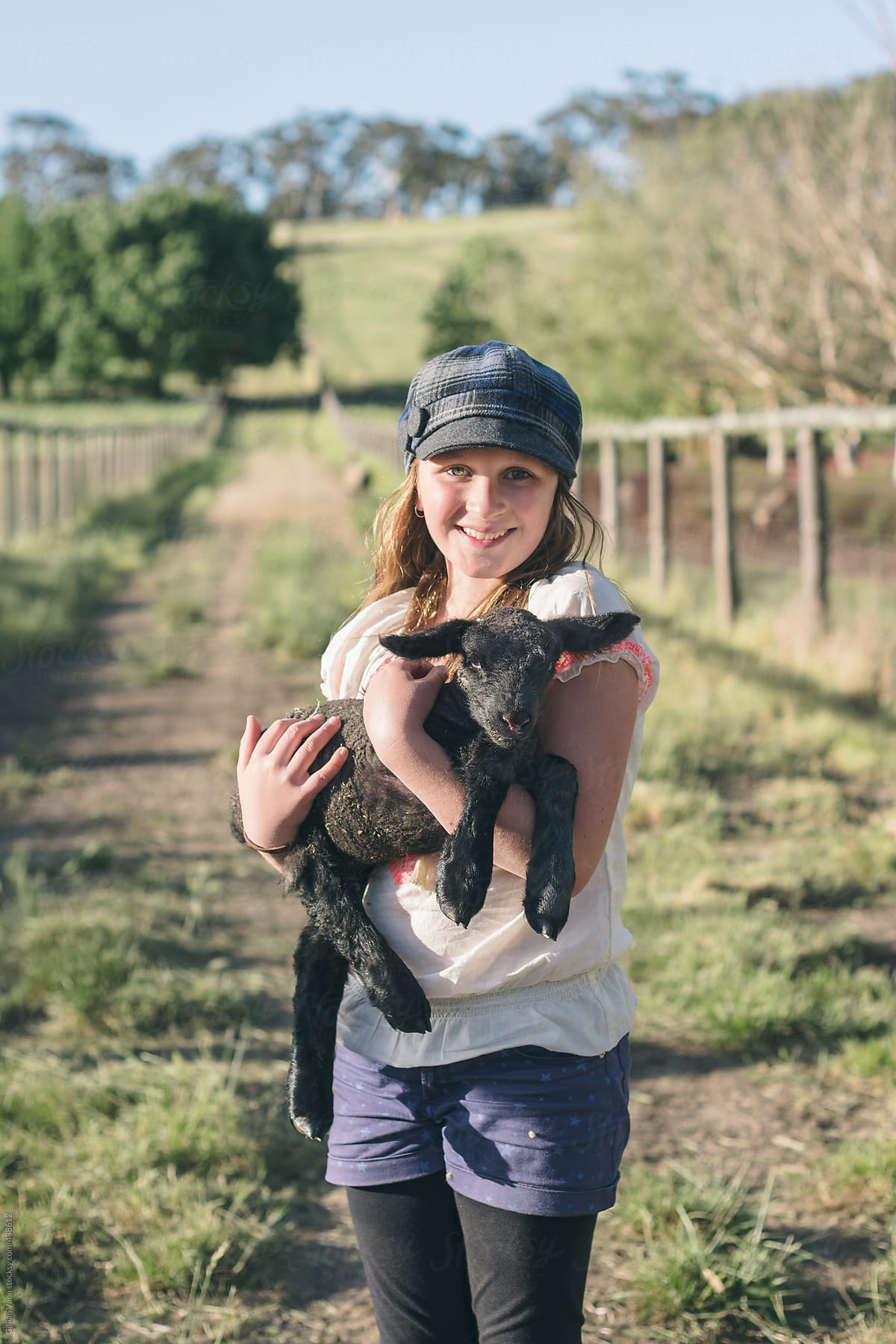 girl holding baby lamb