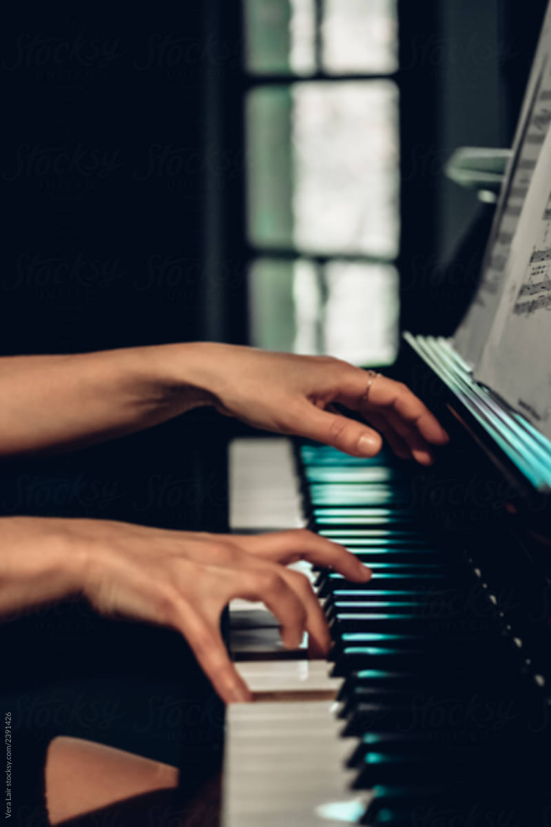 anonymous woman playing piano