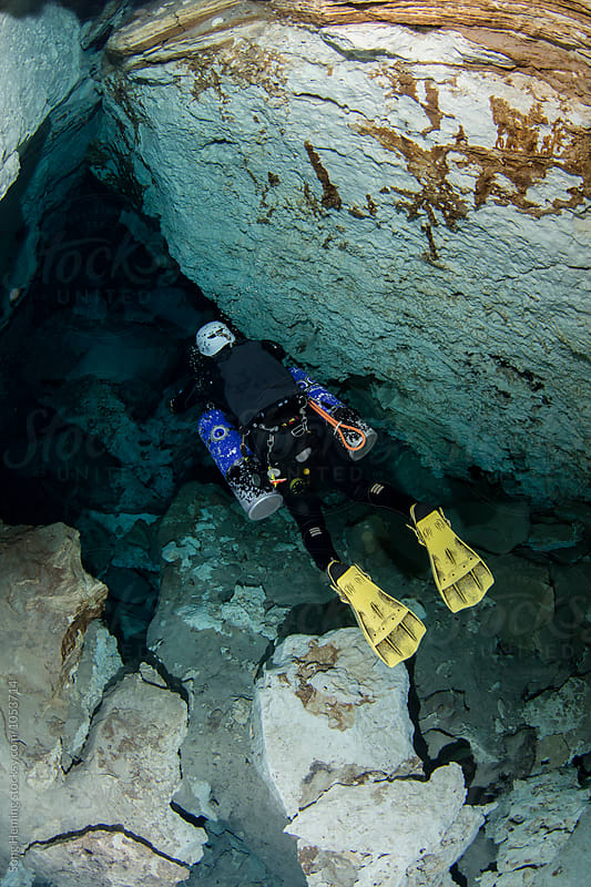 A scuba diver swimming in Mexico's  Cenote Chiken Ha