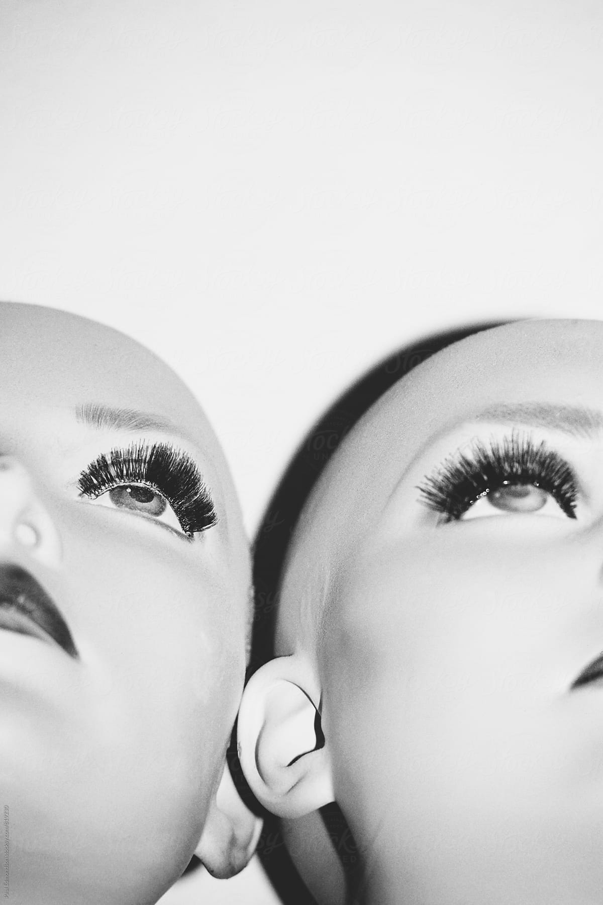 Close up of two female mannequin heads, side by side