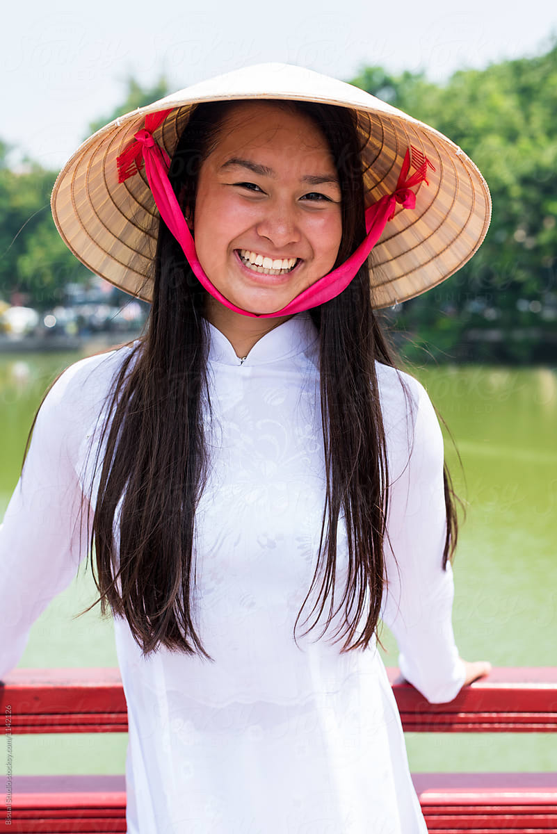 Happy Asian woman near lake