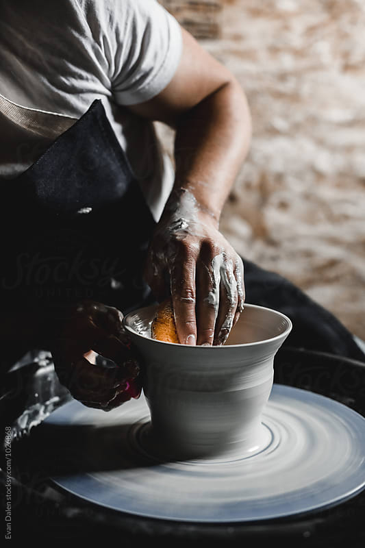 Potter Throwing Clay on Wheel