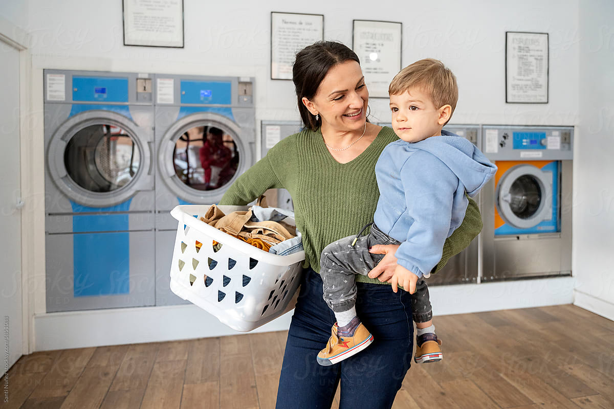 Mother and little boy doing laundry