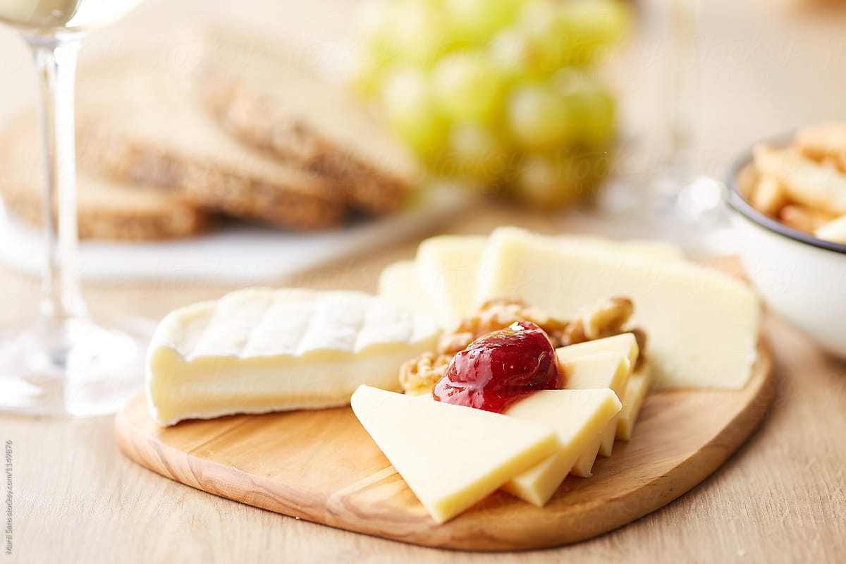 Cheese board with walnuts and jam