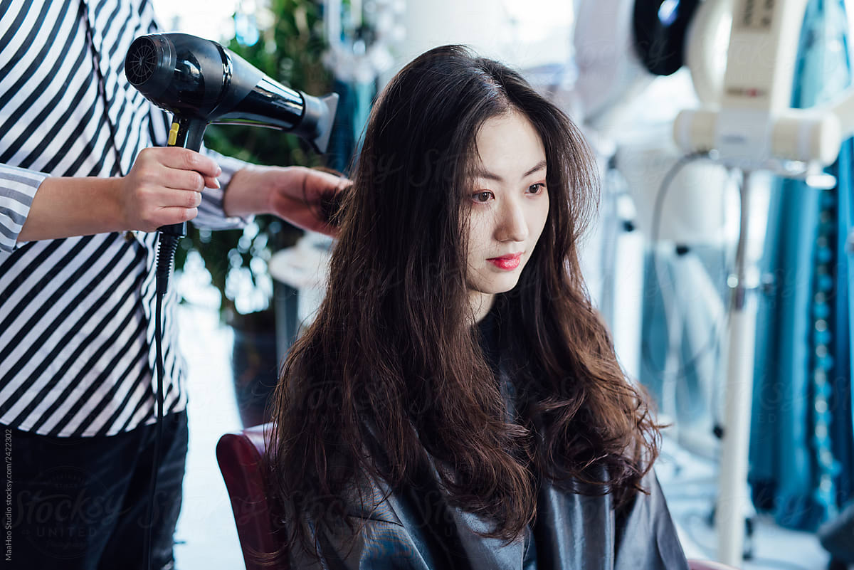 Hairdresser cutting hair in hair salon