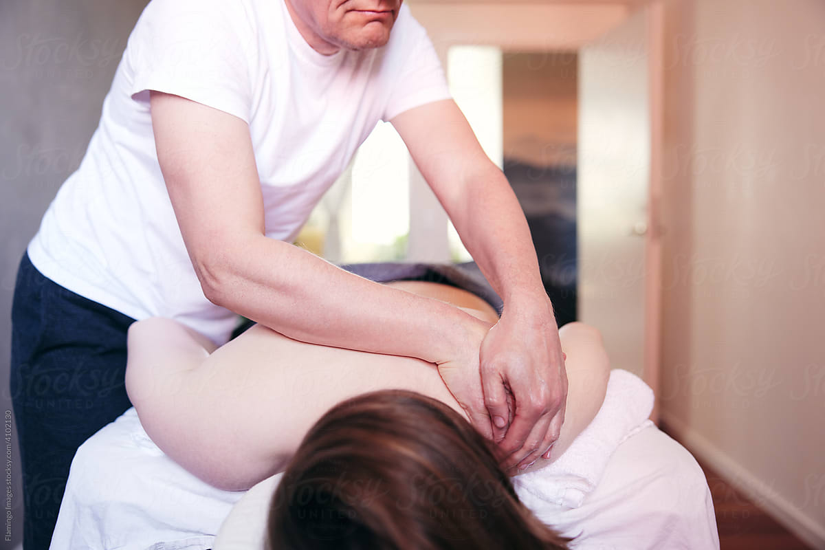 Therapist massaging a client\'s shoulder