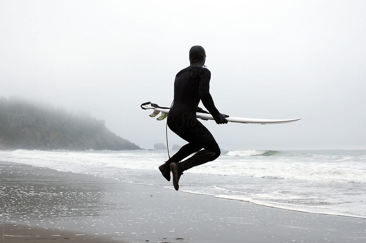 Man jumping with surfboard
