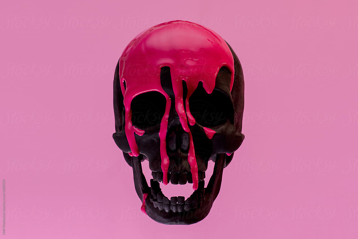 Black Skull with Pink paint running down it against a pink background