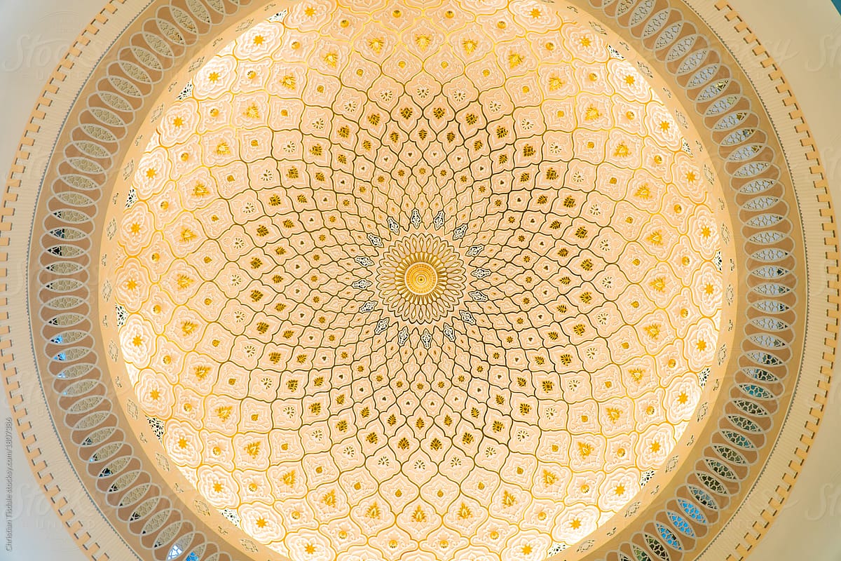 Looking up at the ceiling of a dome in a traditional Islamic building