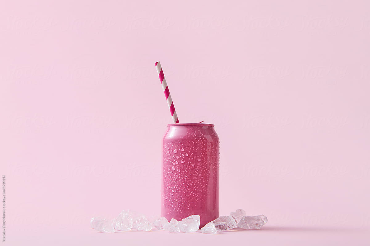 Pink can with paper straw and ice cubes