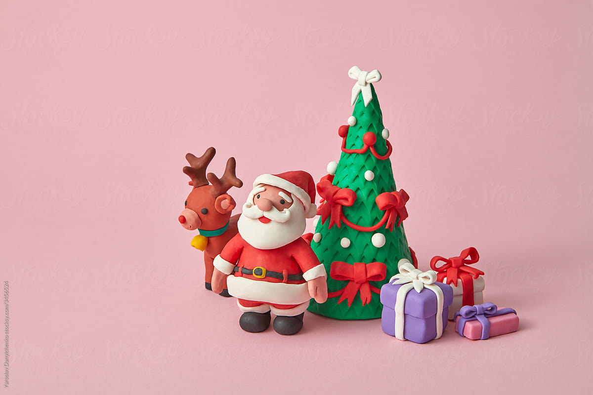 Plasticine Santa Claus with gift boxes and fir tree.